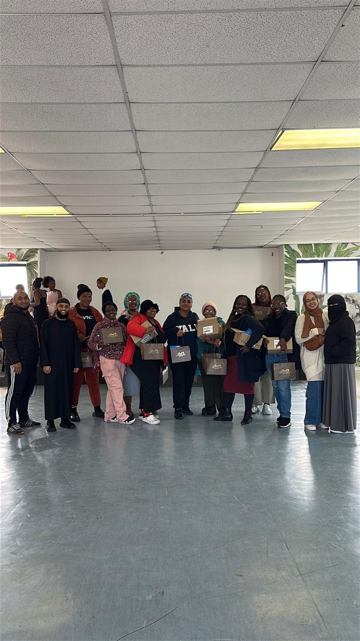 Community members holding food and gift parcels distributed by DailyDawahs during a LightUpLives outreach in Cape Town